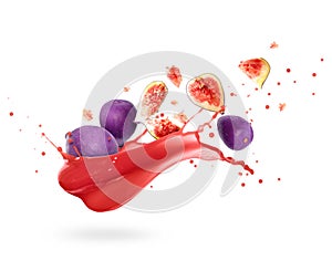 Whole and sliced ripe figs with splashes of fresh juice on white background