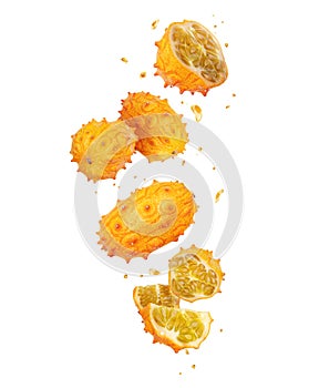 Whole and sliced ripe Kiwano melon Cucumis metuliferus in the air on white background