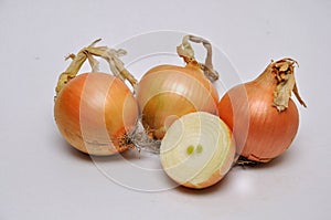 Whole and sliced white onions on a seamless background