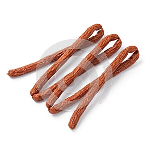 Whole smoked polish cabanossi sausages on white background