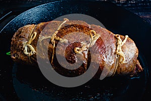 Whole Stuffed Flank Steak with Prosciutto and Mushrooms in a Pan photo