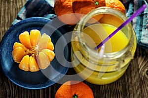 Mandarins and glass jar with juice photo