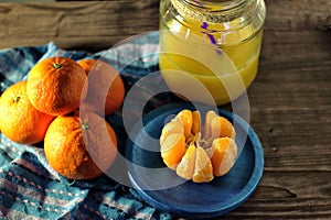 Mandarins and glass jar with juice photo