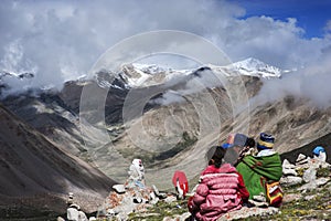 A whole Tibetan family circumambulating Mt. Kailash photo