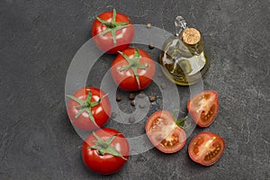 Whole tomato and chopped tomato wedges, allspice on table