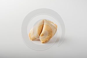 A whole traditional Chinese fortune cookie on a white background.