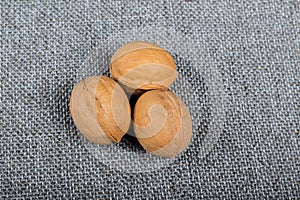 whole walnuts on burlap background, healthy food