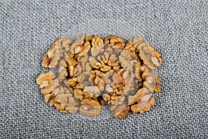 whole walnuts and kernels on burlap background, healthy food