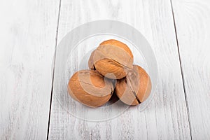 whole walnuts on wooden background, healthy brain food, walnut on light vintage table