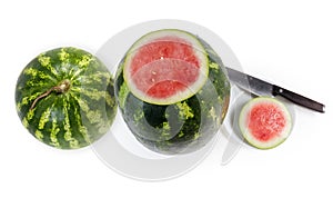 Whole watermelon and watermelon with cut off tip, top view photo