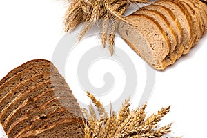 Whole wheat bread. Fresh loaf of rustic traditional bread with wheat grain ear or spike plant isolated on white background. Rye