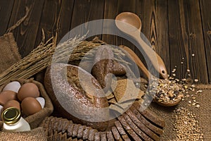 Whole wheat bread,milk,flour and cloth bag on wood table.