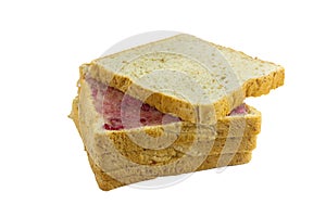 Whole wheat bread stack with grape jam on isolated white background.
