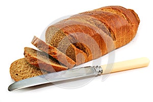 Whole wheat bread and table knife isolated