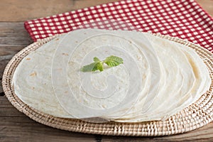 Whole wheat flour tortillas on wooden table.