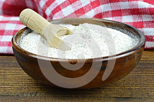 Whole wheat flour in wooden bowl photo