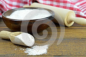 Whole wheat flour in wooden bowl,wooden scoop and rolling pin