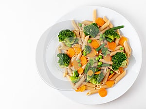 Whole wheat pasta Penne with broccoli, carrots, green peas. Copy space, top view. Diet menu, proper nutrition, healthy food