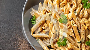 Whole Wheat Penne pasta with gorgonzola cheese sauce, spinach and walnut. Healthy food.