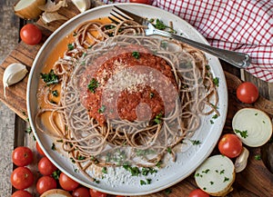 Whole wheat spaghetti with tomato sauce and parmesan cheese