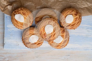 Whole wheat tarts with chocolate frangipane, figs, apple and pears on wooden background, top view