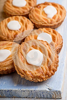 Whole wheat tarts with chocolate frangipane, figs, apple and pears on wooden background, top view