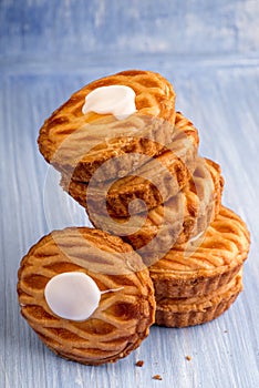 Whole wheat tarts with chocolate frangipane, figs, apple and pears on wooden background, top view