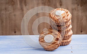 Whole wheat tarts with chocolate frangipane, figs, apple and pears on wooden background, top view