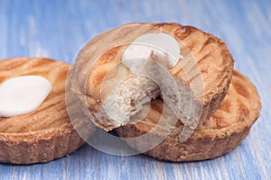 Whole wheat tarts with chocolate frangipane, figs, apple and pears on wooden background, top view