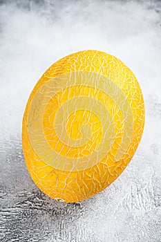 Whole yellow ripe melon. White background. Top view