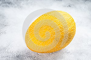 Whole yellow ripe melon. White background. Top view