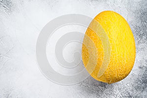 Whole yellow ripe melon. White background. Top view. Copy space