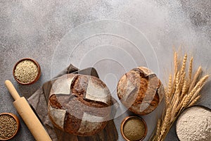 Wholegrain and hemp bread on gray background.