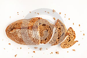 Wholegrain Organic Bread with crumbs isolated on white background. Sliced, cutted wheat bread. Top view. Food