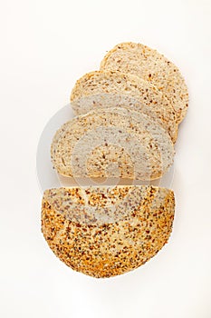 Wholegrain Organic Bread with crumbs isolated on white background. Sliced, cutted wheat bread. Top view. Food