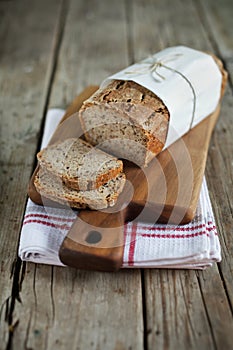 Wholegrain rye bread loaf with flax seeds and oats, sliced photo