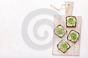 Wholegrain sandwiches with avocado spread, tofu and microgreen photo