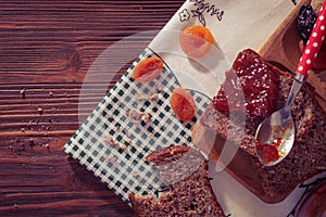 Wholemeal bread with apricot jam surrounded by dry fruit.