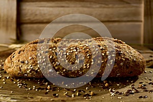 Wholemeal bread roll topped with different seeds