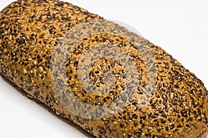 Wholemeal bread with seeds. Closeup. Isolated