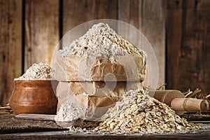 Wholemeal Oat flour and oat flakes, rolling pin, spoon