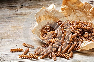 Wholemeal pasta fusilli from organic whole grain spelt falling f