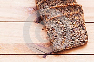Wholemeal, wholewheat bread on wooden table. Organic, healthy food