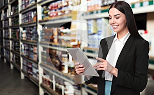 Wholesale and logistics. Manager using tablet computer in warehouse