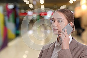 Wholesale and logistics. Manager talking on phone in shopping mall