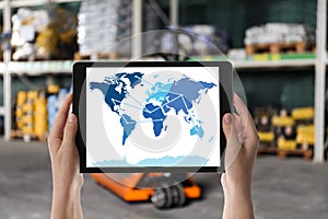 Wholesale trading. Woman tablet with world map illustration at warehouse