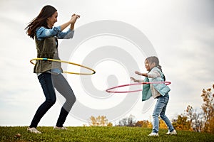 Whoop whoop for the hula hoop. an attractive young woman and her daughter in the park.