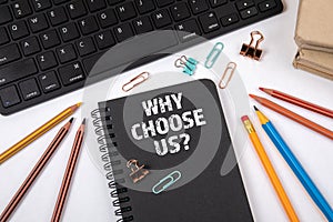 WHY CHOOSE US. Black notebook and computer keyboard