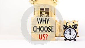 Why choose us symbol. Concept word Why choose us on beautiful wooden block. Black alarm clock. Beautiful white table white