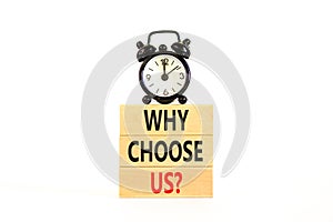 Why choose us symbol. Concept word Why choose us on beautiful wooden block. Black alarm clock. Beautiful white table white